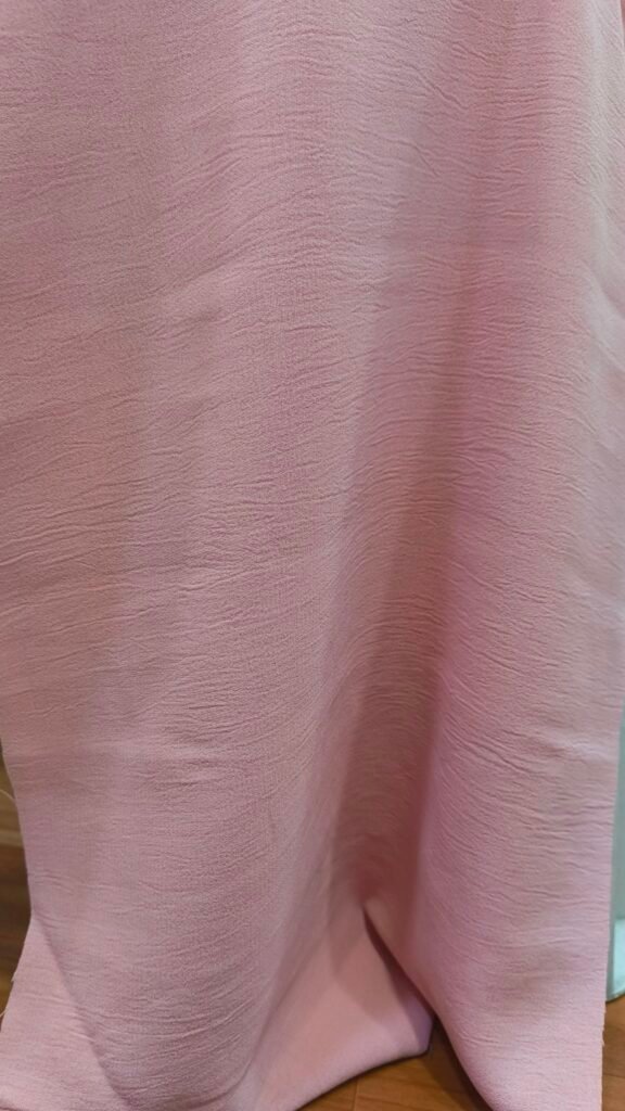 Pink Nylon CEY fabric draped to show its crinkled texture