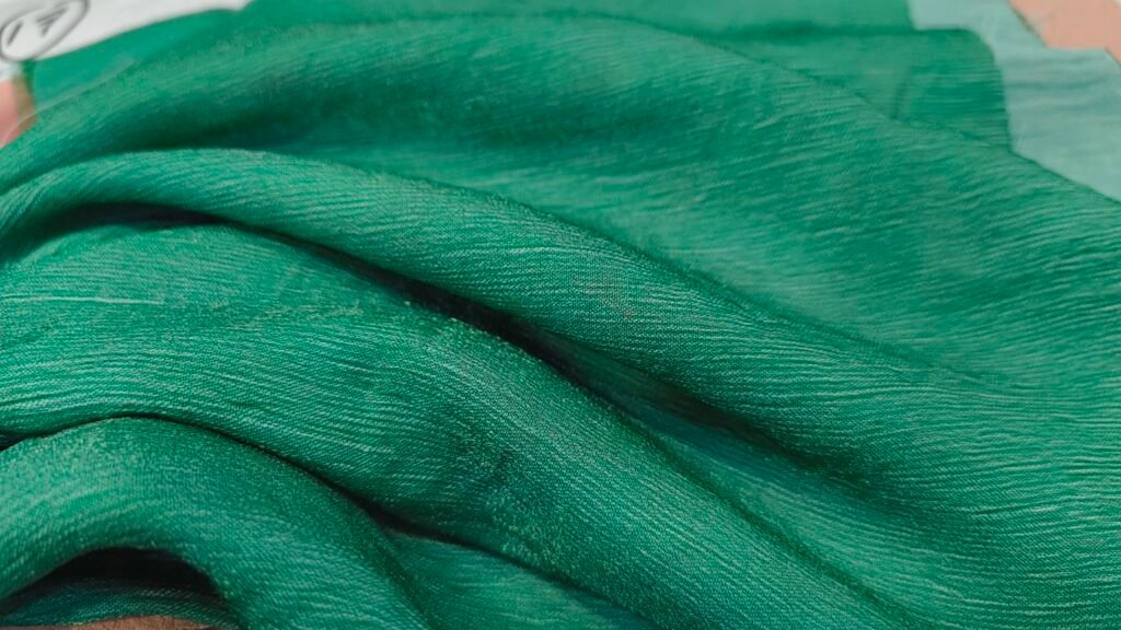 Green Nylon CEY fabric with soft folds and textured weave