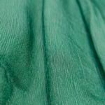 Green Nylon CEY fabric draped in vertical folds