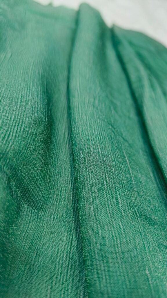 Green Nylon CEY fabric draped in vertical folds